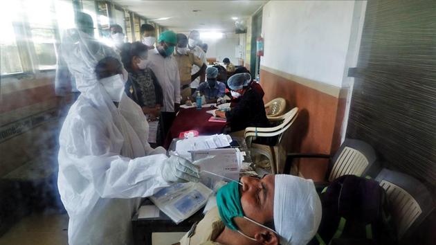 A healthcare worker collects a nasal sample from a policeman during a check-up campaign in Mumbai on September 16. (ANI) A healthcare worker collects a nasal sample from a policeman during a check-up campaign in Mumbai on September 16. (ANI)
