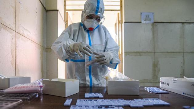 A medical professional in PPE coveralls preserves a swab sample collected to test for Covid-19 infection at Saket in New Delhi on September 16. India crossed the 60-million-mark for coronavirus disease (Covid-19) tests on September 16, HT reported. (Amal KS / HT Photo)