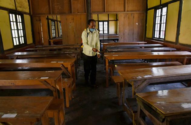 A staff member sprays disinfectant on benches ahead of the reopening of schools from Monday during Unlock 4.0 at the Sonaram Higher Secondary School in Guwahati. (PTI Photo) A staff member sprays disinfectant on benches ahead of the reopening of schools from Monday during Unlock 4.0 at the Sonaram Higher Secondary School in Guwahati. (PTI Photo)