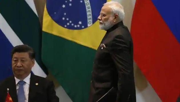 Prime Minister Narendra Modi walks past China’s President Xi Jinping.(File photo)