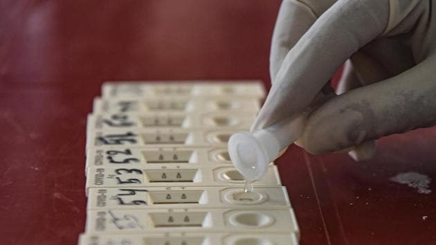 A health worker collects samples for COVID-19 Rapid Antigen test in Srinagar.(PTI)