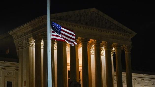 The American flag blows in the wind after it was lowered to half-staff Friday, Sept. 18, 2020, in Washington, after the Supreme Court announced that Supreme Court Justice Ruth Bader Ginsburg has died of metastatic pancreatic cancer at age 87. (AP) The American flag blows in the wind after it was lowered to half-staff Friday, Sept. 18, 2020, in Washington, after the Supreme Court announced that Supreme Court Justice Ruth Bader Ginsburg has died of metastatic pancreatic cancer at age 87. (AP)