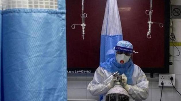 File photo: A medical worker wearing personal protective equipment (PPE) pushes an oxygen cylinder for a patient suffering from the Covid-19. (REUTERS) File photo: A medical worker wearing personal protective equipment (PPE) pushes an oxygen cylinder for a patient suffering from the Covid-19. (REUTERS)