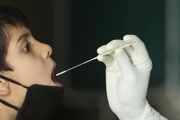 A health worker collects a swab sample to test for Covid-19 at a government hospital in Jammu in this file photo. (AP Photo) A health worker collects a swab sample to test for Covid-19 at a government hospital in Jammu in this file photo. (AP Photo)
