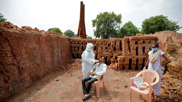 A health care worker takes swab from a man for a rapid antigen test at a brick kiln, in Rajoda, Gujarat on September 18. India’s single-day recoveries have surpassed the number of fresh infections reported for the second consecutive day on September 20 after 94,612 people recovered from the viral disease in the last 24 hours. India saw 92,605 fresh cases of the coronavirus disease during this period. (Amit Dave / REUTERS)