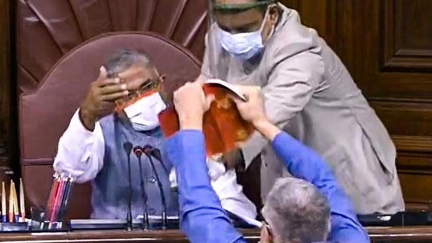 Trinamool Congress MP Derek O’Brien attempts to tear the rule book in Rajya Sabha in protest over the bills at Rajya Sabha in New Delhi on September 20. Opposition members, including those from the TMC, Congress and Left, created ruckus after deputy chairperson Harivansh did not consider their demand for a division of votes on a resolution to send the two bills to a select committee for further scrutiny, HT reported. (PTI) Trinamool Congress MP Derek O’Brien attempts to tear the rule book in Rajya Sabha in protest over the bills at Rajya Sabha in New Delhi on September 20. Opposition members, including those from the TMC, Congress and Left, created ruckus after deputy chairperson Harivansh did not consider their demand for a division of votes on a resolution to send the two bills to a select committee for further scrutiny, HT reported. (PTI)
