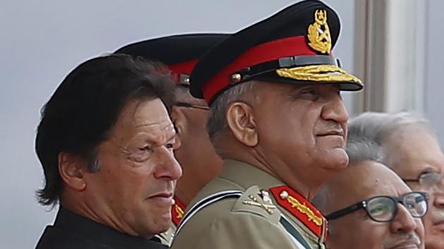 Pakistan's Army Chief Gen. Qamar Javed Bajwa, center, watches a parade with Pakistan Prime Minister Imran Khan.(AP)