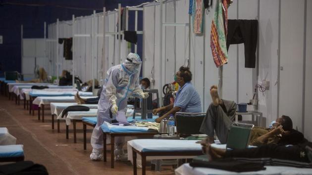 A health worker takes the temperature of a patient at the CWG Village Covid-19 care centre in New Delhi on September 19. The number of active Covid-19 cases in India stands at 1,010,824, while 4,303,043 people have recovered so far. These account for 18.72% of the total cases India has seen until now. (Altaf Qadri / AP) A health worker takes the temperature of a patient at the CWG Village Covid-19 care centre in New Delhi on September 19. The number of active Covid-19 cases in India stands at 1,010,824, while 4,303,043 people have recovered so far. These account for 18.72% of the total cases India has seen until now. (Altaf Qadri / AP)