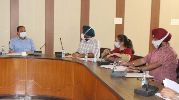 Deputy Commissioner Varinder Kumar Sharma during a meeting with officials to review paddy procurement arrangements in Ludhiana on Monday.(HT photo)