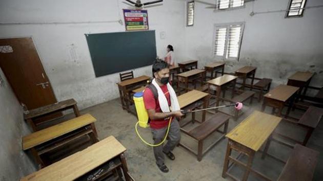 File photo: A worker sanitizes a school building in Jammu.(PTI)