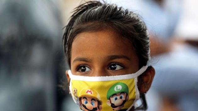 A girl wears a protective mask amidst the spread of the coronavirus disease (Covid-19) in Mumbai, India.(REUTERS)