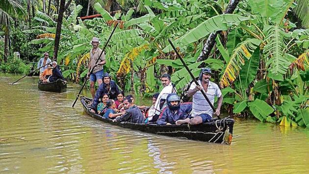 NDRF personnel rescue villagers from Udupi and Dakshina Kannada, in Mangaluru on Sunday.(PTI)