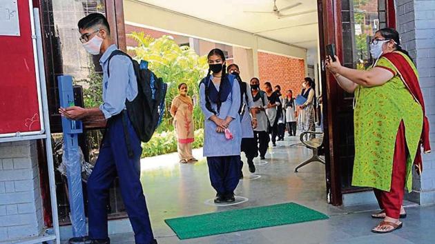 Masks, social distancing, sanitisers and videography — all precautions in place as students return to a government school in Sector 45, Chandigarh, on Monday.(Keshav Singh/HT) Masks, social distancing, sanitisers and videography — all precautions in place as students return to a government school in Sector 45, Chandigarh, on Monday.(Keshav Singh/HT)