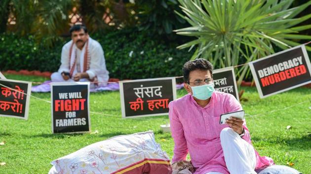Congress MP Rajiv Satav (R) and AAP MP Sanjay Singh stage a protest over their suspension from the remaining Monsoon Session of Parliament over the ruckus created in Rajya Sabha. (PTI)
