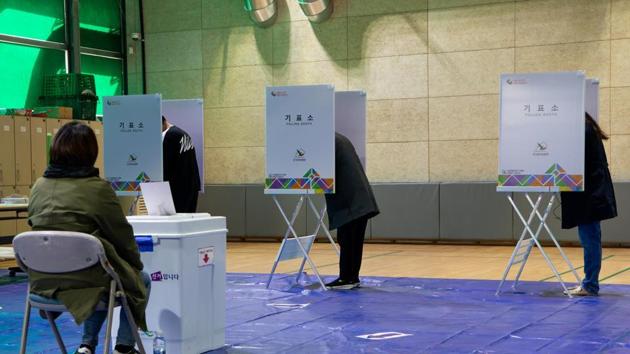 Voters mark their ballots during parliamentary elections in Seoul, South Korea in April.(Bloomberg) Voters mark their ballots during parliamentary elections in Seoul, South Korea in April.(Bloomberg)