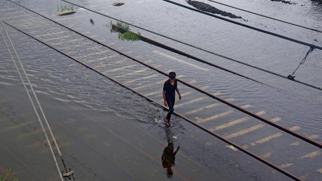 A man walks along submerged railway tracks between Sion and Kurla railway station in Mumbai on September 23. Prior to this 24-hour rain spell, the heaviest rain this season for Mumbai suburbs was recorded between August 3 and 4 at 268.6mm. The highest rain for south Mumbai however was recorded between August 5 and 6 at 331.2mm. (Vijayanand Gupta / HT Photo) A man walks along submerged railway tracks between Sion and Kurla railway station in Mumbai on September 23. Prior to this 24-hour rain spell, the heaviest rain this season for Mumbai suburbs was recorded between August 3 and 4 at 268.6mm. The highest rain for south Mumbai however was recorded between August 5 and 6 at 331.2mm. (Vijayanand Gupta / HT Photo)