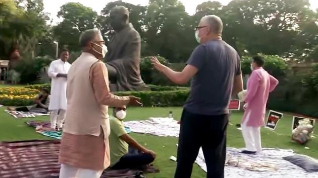 Rajya Sabha Deputy Chairman Harivansh meeting Rajya Sabha MPs who were protesting at Gandhi statue against their suspension from the House, over farm bill fracas, on Tuesday. (ANI Photo)