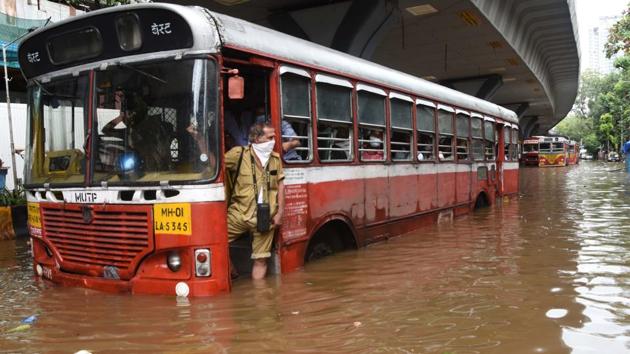 A Brihanmumbai Electricity Supply and Transport (BEST) conductor looks out from a bus stuck in a waterlogged stretch at Lalbaug in Mumbai on September 23. Mumbai’s suburbs witnessed an incessant downpour between September 22 evening and September 23 morning. This is the heaviest rain the suburbs have received this season and the second-highest 24-hour September spell in 26 years (1994-2020), HT reported. (Bhushan Koyande / HT Photo)