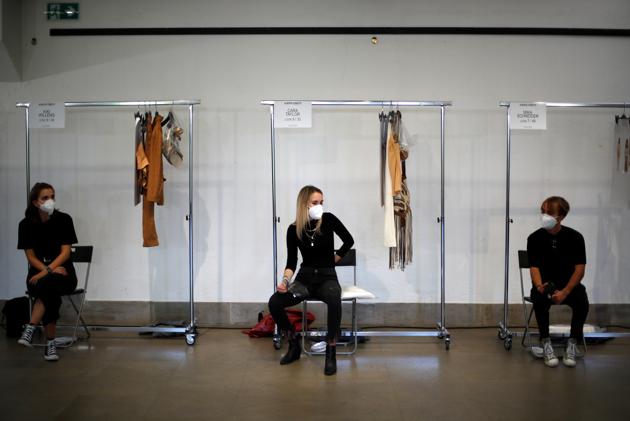 Models sit on backstage before presenting creations from the Alberta Ferretti Spring/Summer 2021 women's collection during fashion week in Milan, Italy, September 23, 2020.  (REUTERS) 