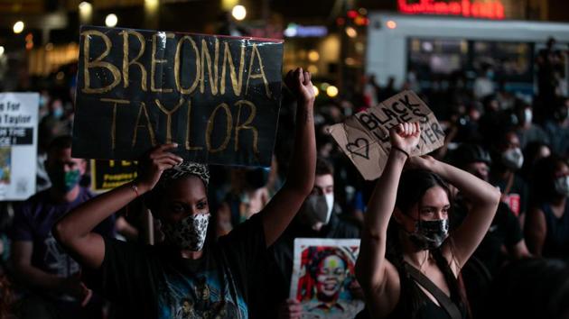 People hold placards during a march following the announcement of a single indictment in the Breonna Taylor case, in the Manhattan borough of New York City, New York.(Reuters)