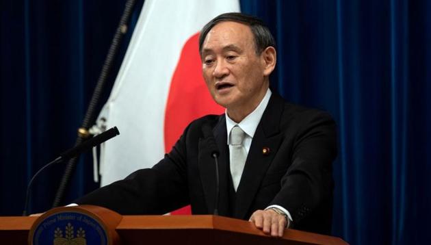 FILE PHOTO: Yoshihide Suga speaks during a news conference following his confirmation as Prime Minister of Japan in Tokyo, Japan September 16, 2020 (Carl Court/Pool via REUTERS/File Photo)
