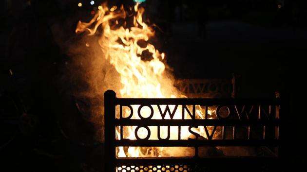 A trash can ignited by demonstrators burns outside the Louisville Hall of Justice during a protest in Louisville on September 23. In announcing the grand jury’s conclusions, Kentucky Attorney General Daniel Cameron said the panel had declined to bring any charges whatsoever against two of the three white policemen who fired into Taylor’s apartment on March 13. (Luke Sharrett / Bloomberg) A trash can ignited by demonstrators burns outside the Louisville Hall of Justice during a protest in Louisville on September 23. In announcing the grand jury’s conclusions, Kentucky Attorney General Daniel Cameron said the panel had declined to bring any charges whatsoever against two of the three white policemen who fired into Taylor’s apartment on March 13. (Luke Sharrett / Bloomberg)