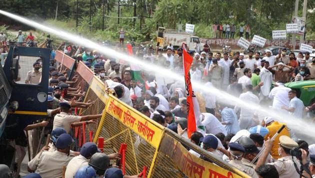 Youth Congress workers protest against the farm bills are dispersed by police using a water canon in Karnal, Haryana on Wednesday.(HT Photo)