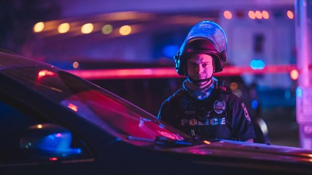 A police officer stands behind a vehicle during the protest in Louisville on September 23. The demonstrations remained mostly peaceful until several gunshots rang out as heavily armed police closed in on a throng of protesters at nightfall. Two officers were shot and wounded, interim Louisville Metropolitan Police chief Robert Schroeder told Reuters. (Jon Cherry / AFP) A police officer stands behind a vehicle during the protest in Louisville on September 23. The demonstrations remained mostly peaceful until several gunshots rang out as heavily armed police closed in on a throng of protesters at nightfall. Two officers were shot and wounded, interim Louisville Metropolitan Police chief Robert Schroeder told Reuters. (Jon Cherry / AFP)