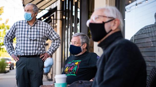 Cliff Lewis, 65, from left, Bob Humrick, 71, a retired chemist, and Kermit Lind, 78, a former college professor, outside the Phoenix Coffee in Cleveland Heights, Ohio, U.S., on Saturday, Sept. 19, 2020. For years, the Phoenix coffee house on Lee Road was a haven for a group of old friends in Cleveland Heights, Ohio. (Bloomberg) Cliff Lewis, 65, from left, Bob Humrick, 71, a retired chemist, and Kermit Lind, 78, a former college professor, outside the Phoenix Coffee in Cleveland Heights, Ohio, U.S., on Saturday, Sept. 19, 2020. For years, the Phoenix coffee house on Lee Road was a haven for a group of old friends in Cleveland Heights, Ohio. (Bloomberg)