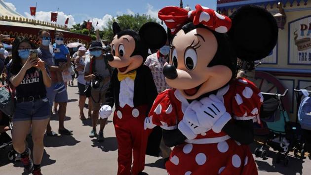 The iconic cartoon characters Minnie and Mickey Mouse walk with the visitors at the Hong Kong Disneyland .(AP)