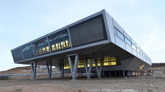 Bharati, which opened in 2012, pioneered the use of shipping containers as part of the core structure, saving assembly time and money. Some 134 of them form an insulated three-level base that includes living areas, a kitchen and gym, offices, labs, workspaces and support areas. (Courtesy Bof Architekten)