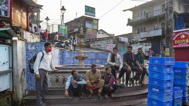 Daily-wage laborers wearing masks as protection against the coronavirus wait to get work at a town square in Dharmsala. (AP) Daily-wage laborers wearing masks as protection against the coronavirus wait to get work at a town square in Dharmsala. (AP)