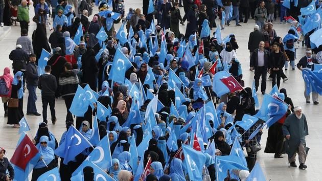 In this file photo from November 6, 2018, people from the Uighur community living in Turkey carry flags of what ethnic Uighurs call 'East Turkestan', during a protest in Istanbul, against what they allege is oppression by the Chinese government to Muslim Uighurs in far-western Xinjiang province.(AP File)