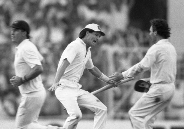 FILE - In this Nov. 8, 1987 file photo, Australian batsman Dean Jones holds the stumps as he races to embrace team captain Allan Border, right, in a moment of jubilation, in Calcutta, India. Jones has died of an apparent heart attack while in India to commentate on the Indian Premier League, it was reported on Thursday, Sept. 24, 2020. He was 59. Jones represented Australia in 52 tests and 164 one-day internationals. (AP Photo/Liu Heung Shing, File)(AP)