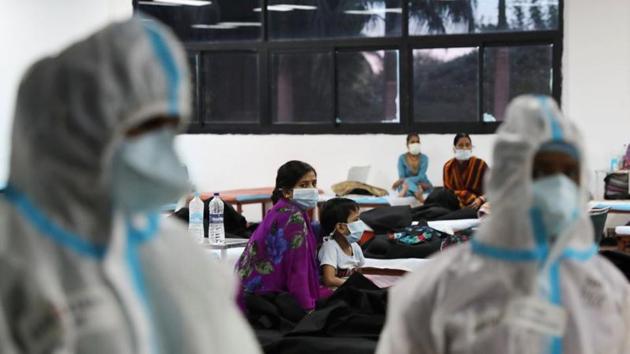 A woman sits with her child inside a quarantine centre for the coronavirus disease patients amidst the spread of the disease at an indoor sports complex in New Delhi, India.(REUTERS) A woman sits with her child inside a quarantine centre for the coronavirus disease patients amidst the spread of the disease at an indoor sports complex in New Delhi, India.(REUTERS)