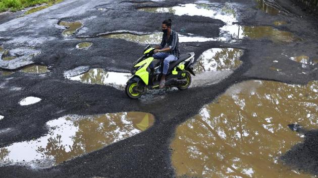 A motorist drives past large potholes in Santacruz, Mumbai on September 24. The BMC has attributed Mumbai’s dip in CFR to weekly monitoring at private and municipal hospitals as part of its ‘Mission Save Lives’ launched in June. CFR is deaths due to Covid-19 as a per cent of the total cases reported. (Satyabrata Tripathy / HT Photo) A motorist drives past large potholes in Santacruz, Mumbai on September 24. The BMC has attributed Mumbai’s dip in CFR to weekly monitoring at private and municipal hospitals as part of its ‘Mission Save Lives’ launched in June. CFR is deaths due to Covid-19 as a per cent of the total cases reported. (Satyabrata Tripathy / HT Photo)