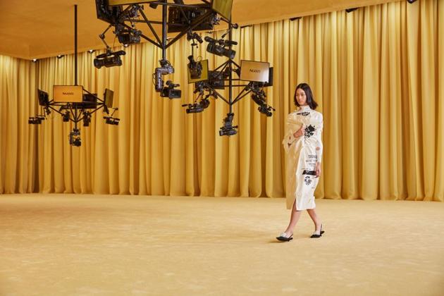 Suspended cameras capture a images and videos of a model as she presents a creation from the Prada Spring/Summer 2021 women's collection during fashion week in Milan, Italy, in this handout photo released on September 24, 2020. (via REUTERS) Suspended cameras capture a images and videos of a model as she presents a creation from the Prada Spring/Summer 2021 women's collection during fashion week in Milan, Italy, in this handout photo released on September 24, 2020. (via REUTERS)