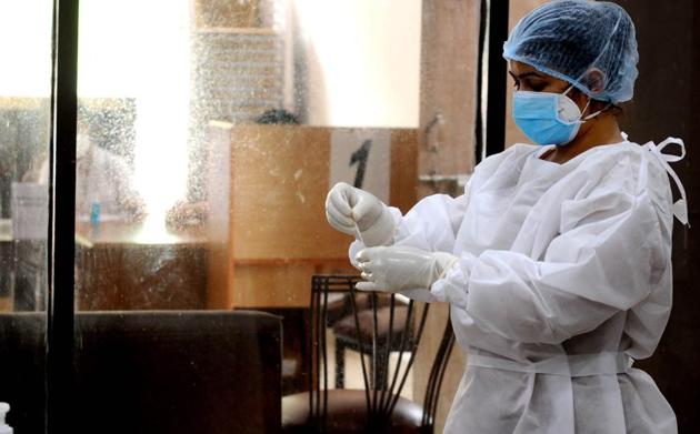 A doctor collecting a sample for Rapid Antigen Test in a special testing camp organised for media personnel by the Chandigarh Press Club in Sector 27, Chandigarh, on Friday.(Ravi Kumar/HT)