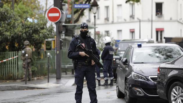 A French riot police officer stands guard after a knife attack near the former offices of satirical newspaper Charlie Hebdo, Friday Sept. 25, 2020 in Paris.(AP)
