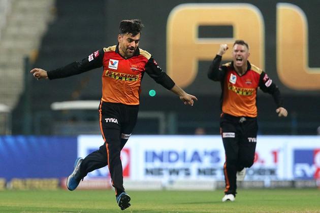 Abu Dhabi: Rashid Khan of Sunrisers Hyderabad with skipper David Warner celebrates the wicket of Dinesh Karthik of Kolkata Knight Riders during their Indian Premier League 2020 cricket match at the Sheikh Zayed Stadium, Abu Dhabi, Saturday, Sept. 26,2020. (PTI Photo/Sportzpics for BCCI) (PTI26-09-2020_000177B) (PTI)