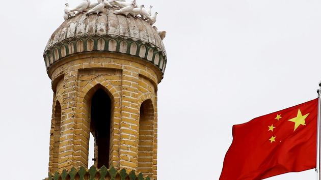 A Chinese national flag flutters near a minaret of the ancient Id Kah Mosque in the Old City in Kashgar in Xinjiang. (Reuters) A Chinese national flag flutters near a minaret of the ancient Id Kah Mosque in the Old City in Kashgar in Xinjiang. (Reuters)
