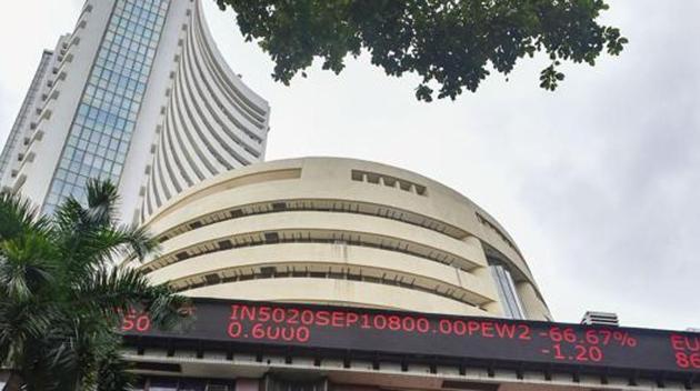 Mumbai: People watch stock prices on the facade of BSE building in Mumbai.(PTI File Photo) Mumbai: People watch stock prices on the facade of BSE building in Mumbai.(PTI File Photo)