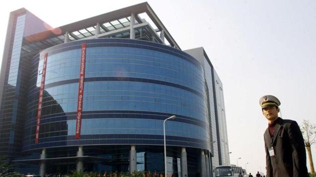 A security officer stands outside a building of Semiconductor Manufacturing International Corporation (SMIC) during its grand opening in Shanghai.(REUTERS) A security officer stands outside a building of Semiconductor Manufacturing International Corporation (SMIC) during its grand opening in Shanghai.(REUTERS)