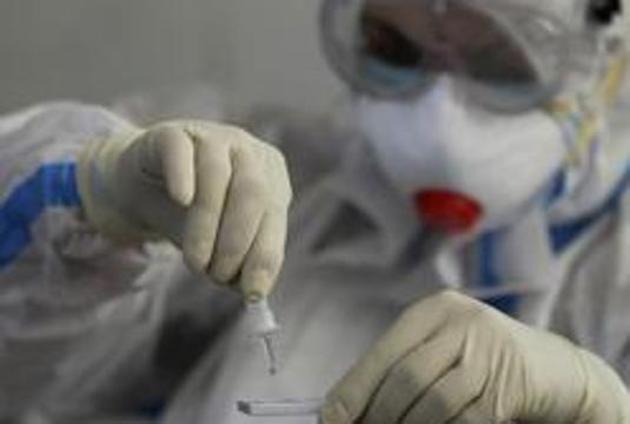 A health worker tests employees of a university for Covid-19.(AP) A health worker tests employees of a university for Covid-19.(AP)