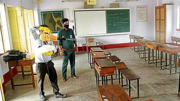 A staff member disinfectants benches at St. Dominic Savio’s High School, Digha in Patna on Saturday(Santosh Kumar /HT) A staff member disinfectants benches at St. Dominic Savio’s High School, Digha in Patna on Saturday(Santosh Kumar /HT)