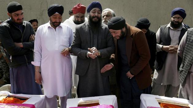 In this Thursday, March 26, 2020 file photo, Afghan Sikh men mourn their beloved ones during a funeral procession for those who were killed on Wednesday by a lone Islamic State gunman, rampaged through a Sikh house of worship, in Kabul, Afghanistan.(AP)