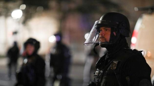 Police officers stand guard during a rally against police violence and racial inequality in Portland, Oregon.(REUTERS) Police officers stand guard during a rally against police violence and racial inequality in Portland, Oregon.(REUTERS)