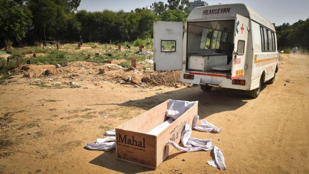 A coffin placed outside an ambulance during the funeral of a Covid-19 victim at ITO Graveyard in New Delhi, India on September 27. India has recorded 94,503 Covid-19 deaths as of September 27 and is fast approaching the 100,000 mark by adding an average of 1,109 deaths a day in the past week. (Sanchit Khanna / HT Photo)