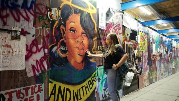 A woman pays homage next to a Breonna Taylor mural, in Washington on September 24. Anti-racism protests and the police response to them continues to help shape the US presidential campaign. President Trump has touted himself as the law-and-order candidate while Biden’s speeches have focused on Covid-19 and the Trump administration’s mismanaging of it. (Cheriss May / REUTERS) A woman pays homage next to a Breonna Taylor mural, in Washington on September 24. Anti-racism protests and the police response to them continues to help shape the US presidential campaign. President Trump has touted himself as the law-and-order candidate while Biden’s speeches have focused on Covid-19 and the Trump administration’s mismanaging of it. (Cheriss May / REUTERS)