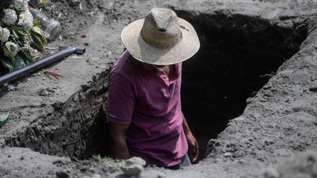 A gravedigger works at the San Miguel Xico cemetery in Mexico City on September 24. The over 1 million deaths attributed to the coronavirus in nine months are far more than the 690,000 from AIDS or the 400,000 from malaria in all of 2019. They’re just behind the 1.5 million from tuberculosis, the AP reports. (Pedro Pardo / AFP)